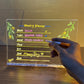 LED light-up writing board displaying a colorful weekly planner with handwritten notes on acrylic surface.